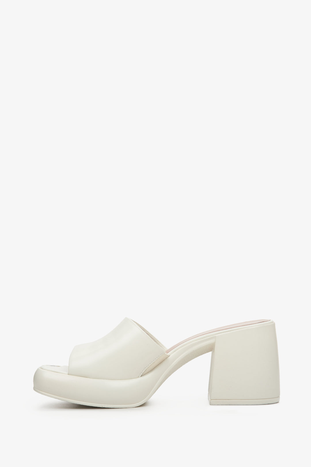 Stylish white mules for women made of natural leather on a square heel - the profile of the shoes.