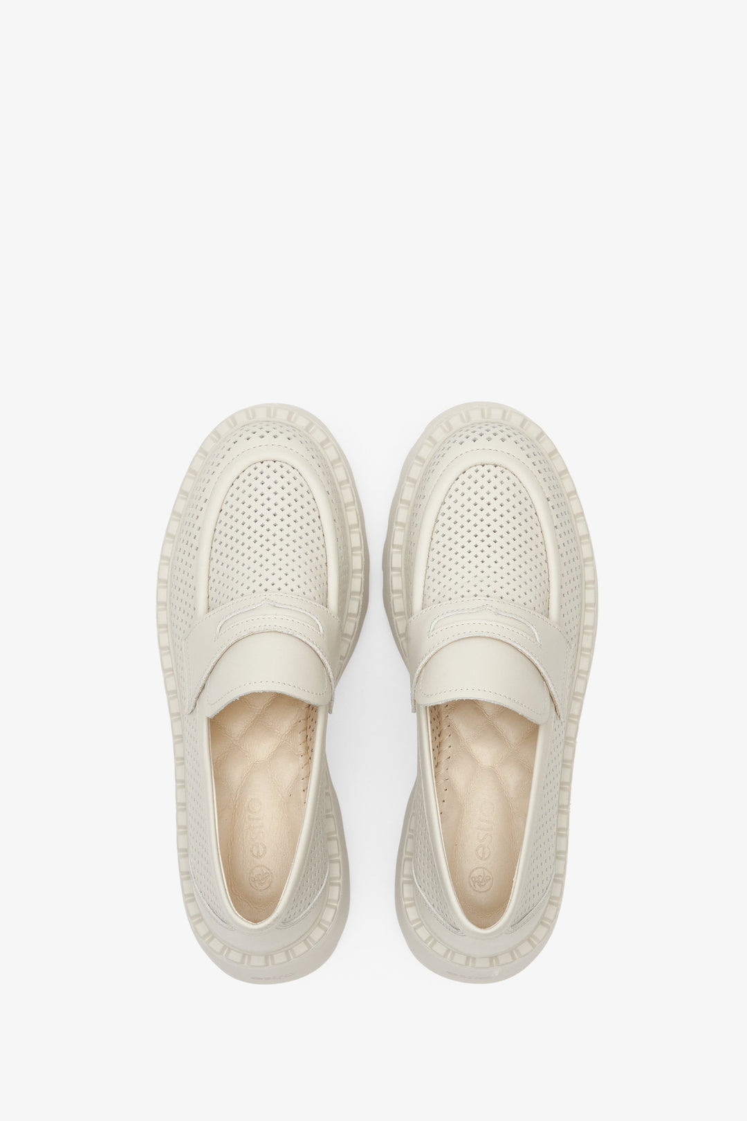 Women's leather loafers with perforation in light beige color - shoe presentation from above.