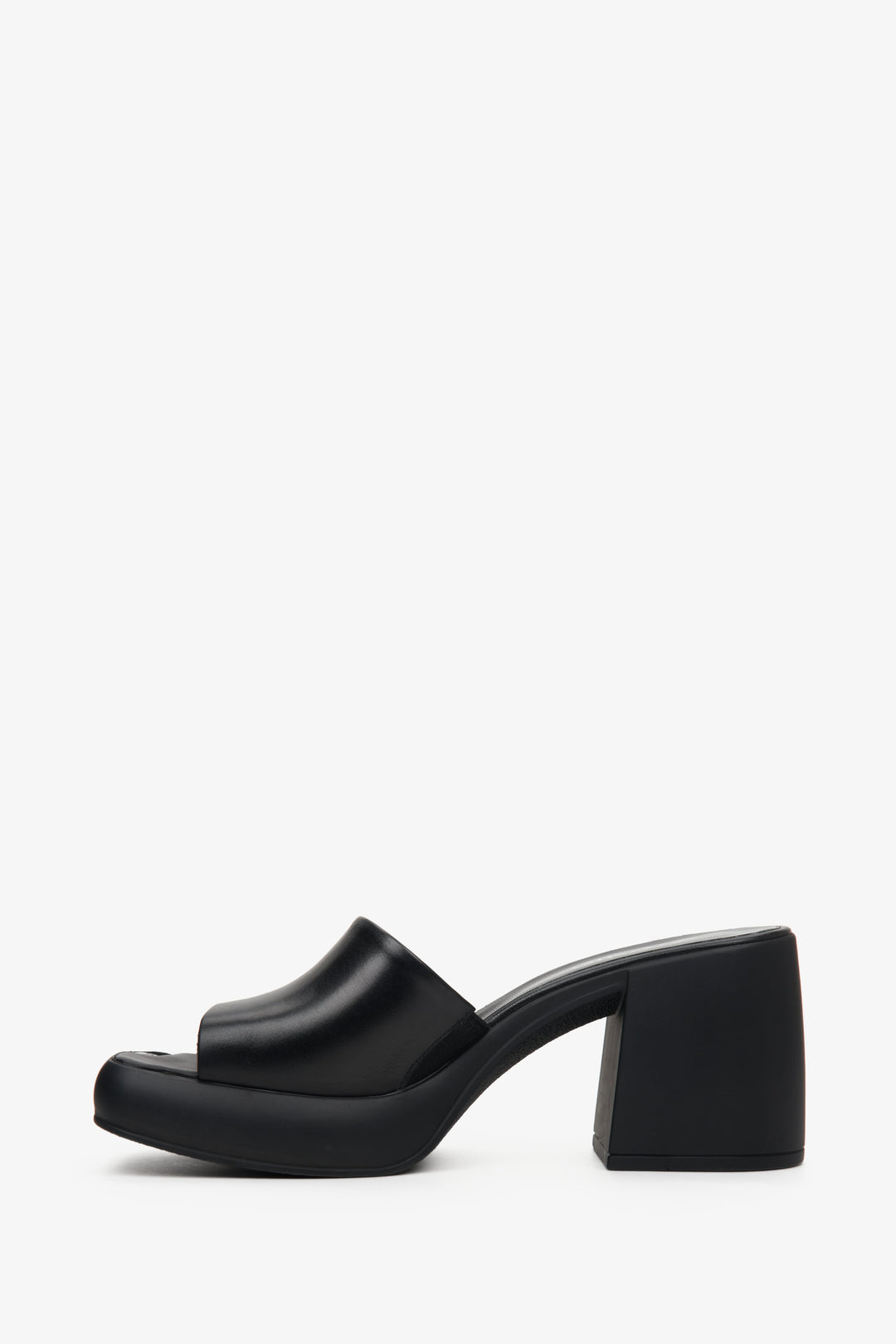 Stylish black mules for women made of natural leather on a square heel - the profile of the shoes.