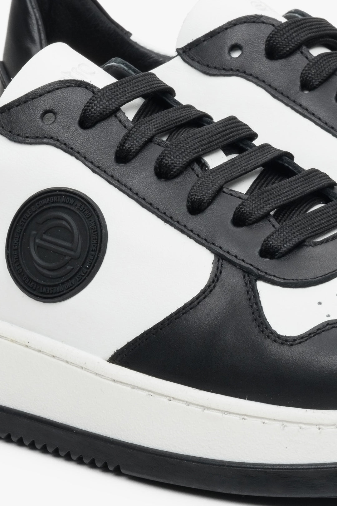 Men's sneakers made of Italian leather, black and white - close-up of details.