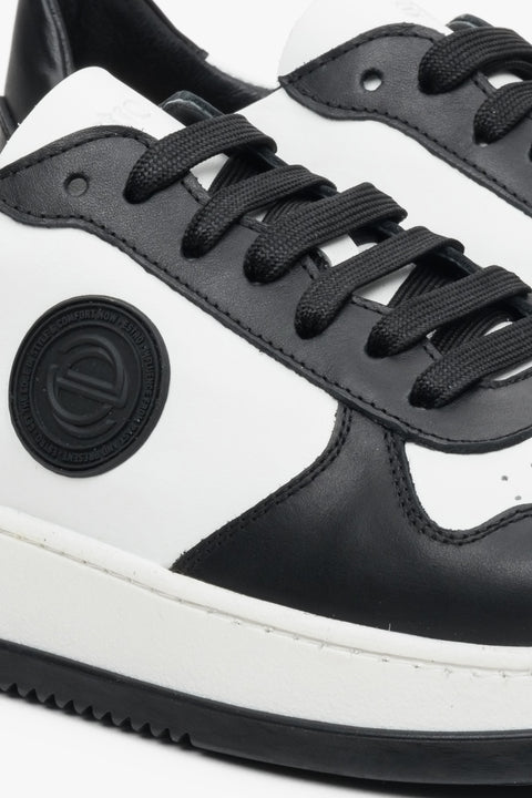 Men's sneakers made of Italian leather, black and white - close-up of details.