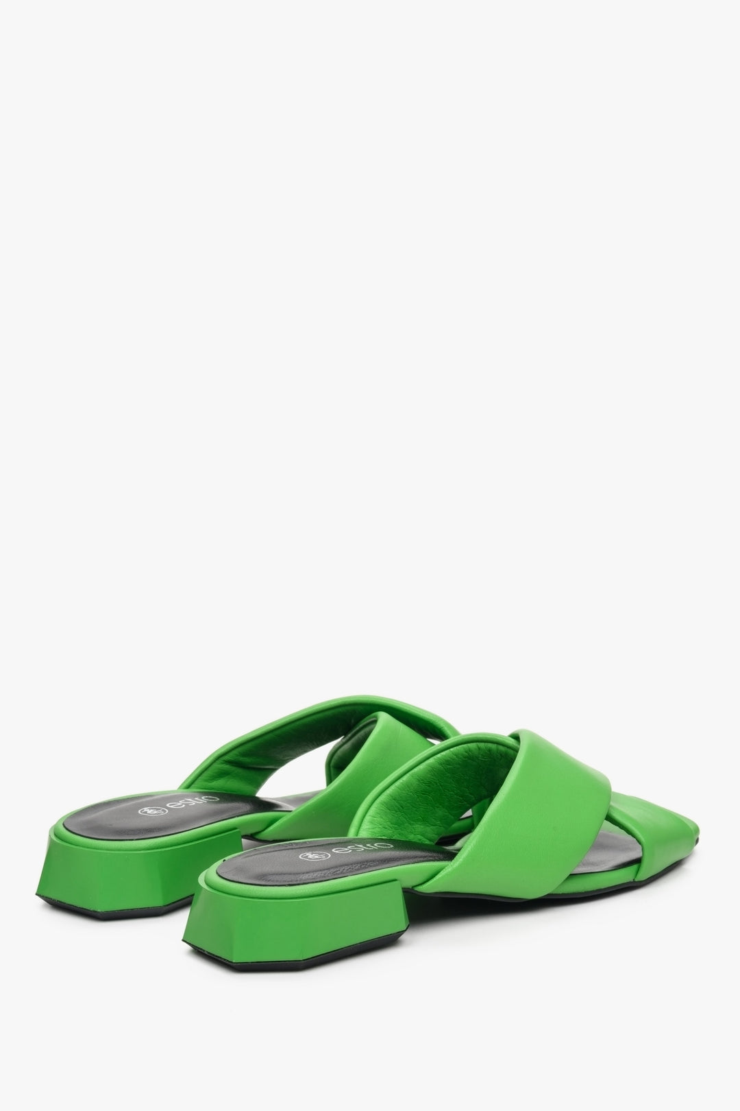Women's low-heeled leather mules in green - close-up on back tip of the shoe.