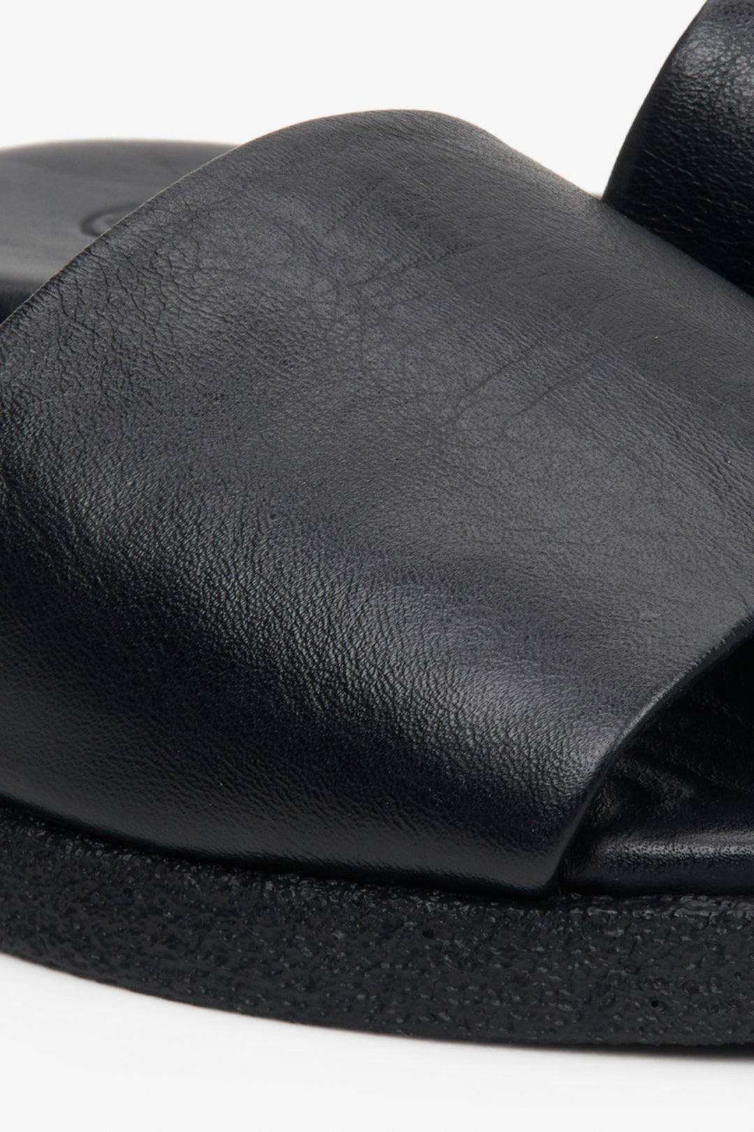 Women's black Estro flat slides - close-up on details.