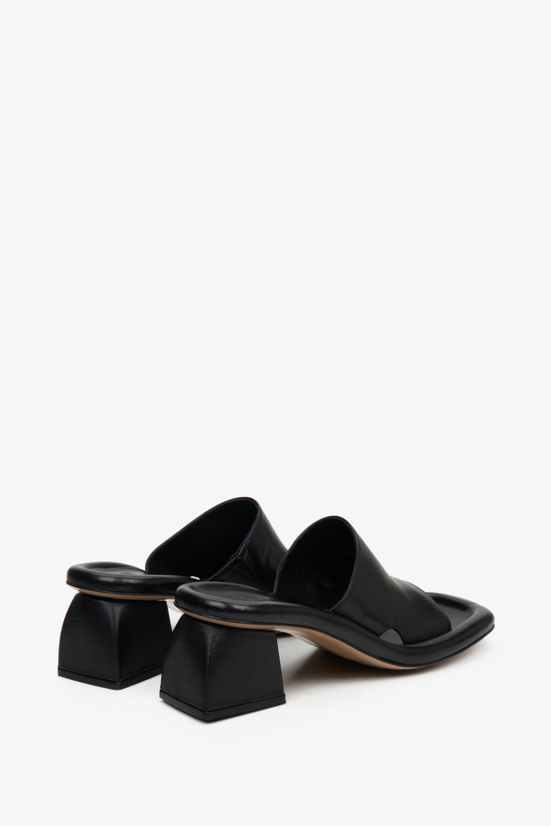 Women's black mules with a square heel - a close-up of the back of the shoes.