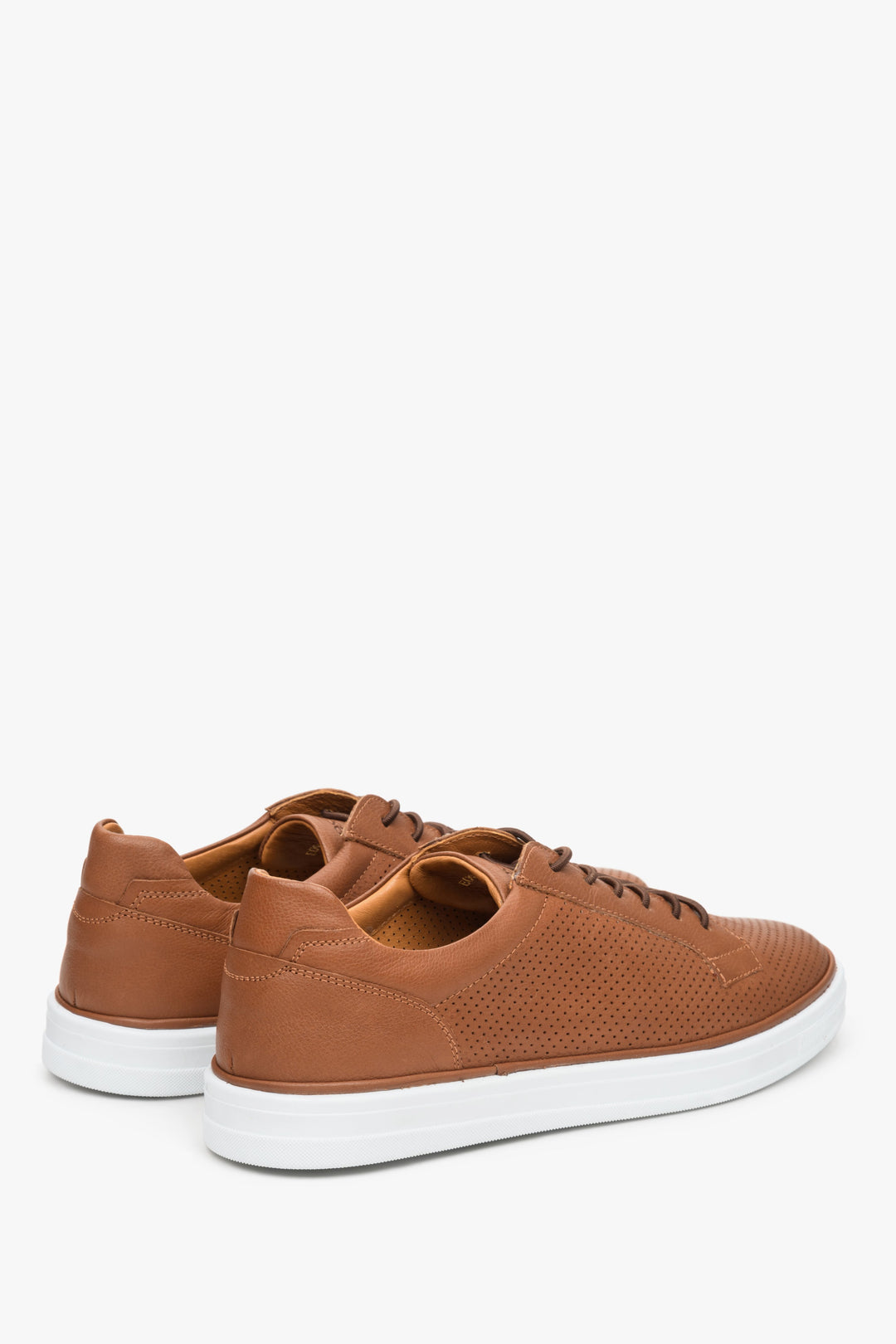 Brown men's natural leather sneakers for summer with perforations - close-up on the sideline of the shoe.