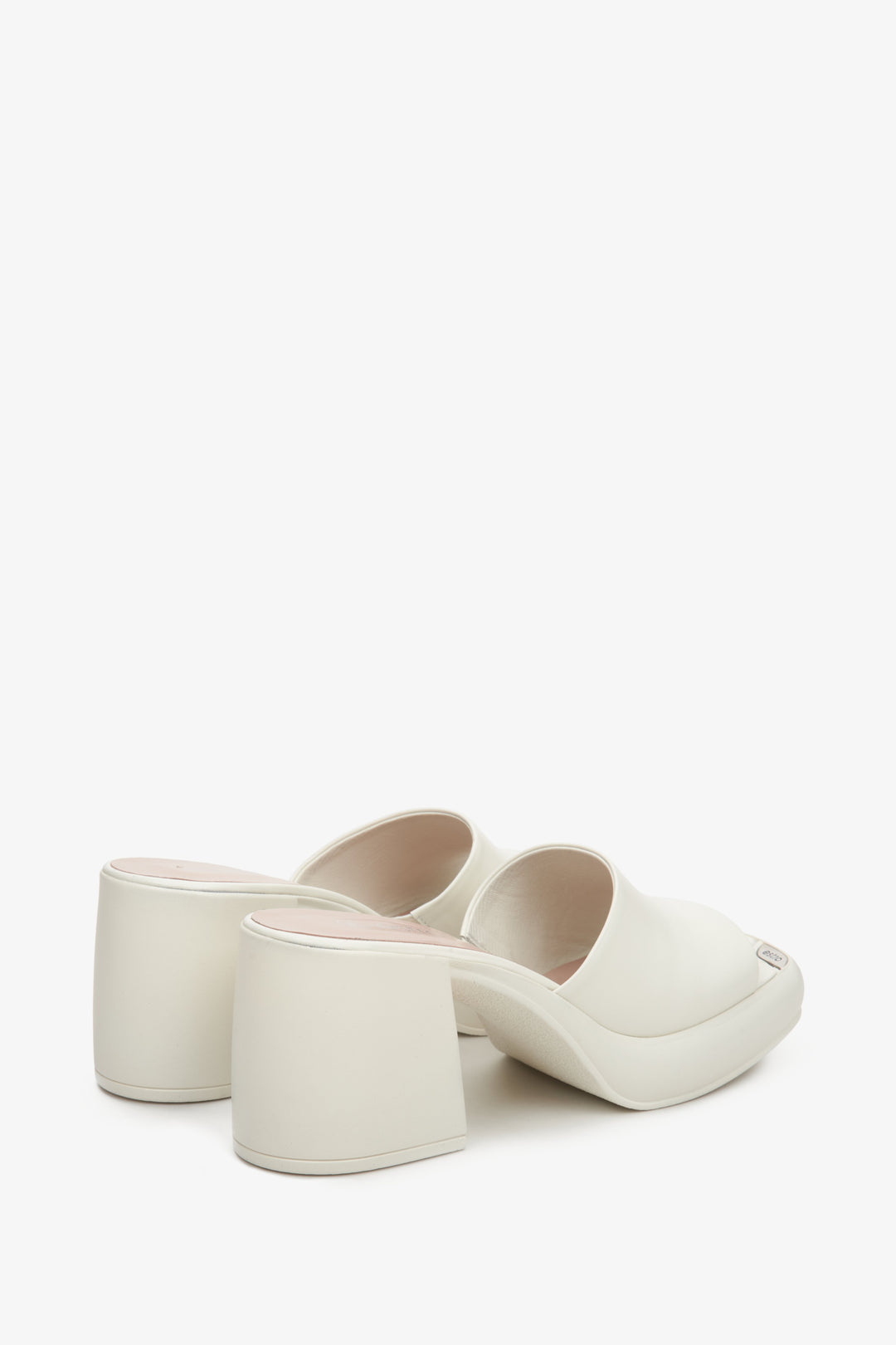 Women's white mules with a square heel - a close-up of the back of the shoes.