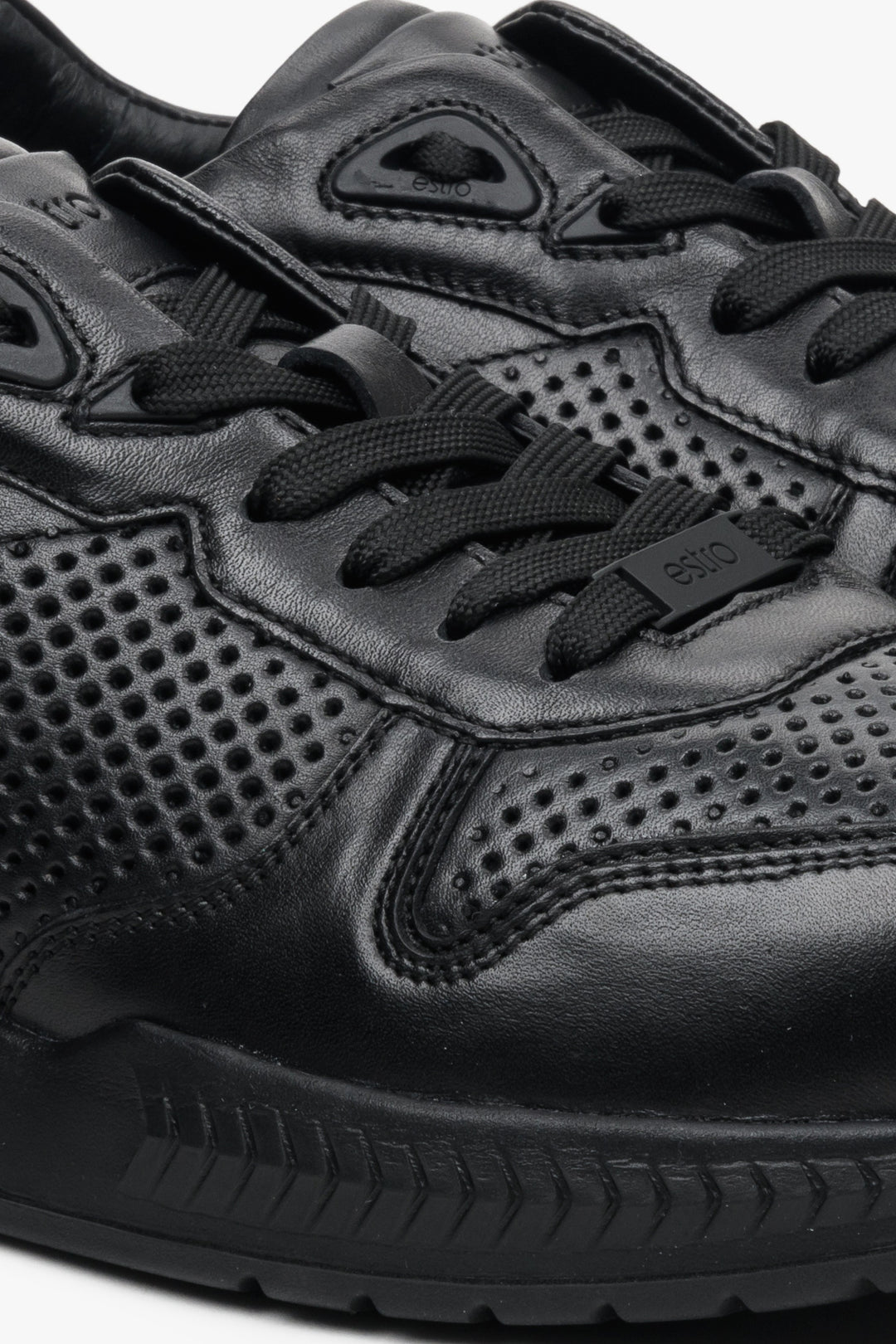 Men's black leather Estro sneakers with perforations - close-up on details.