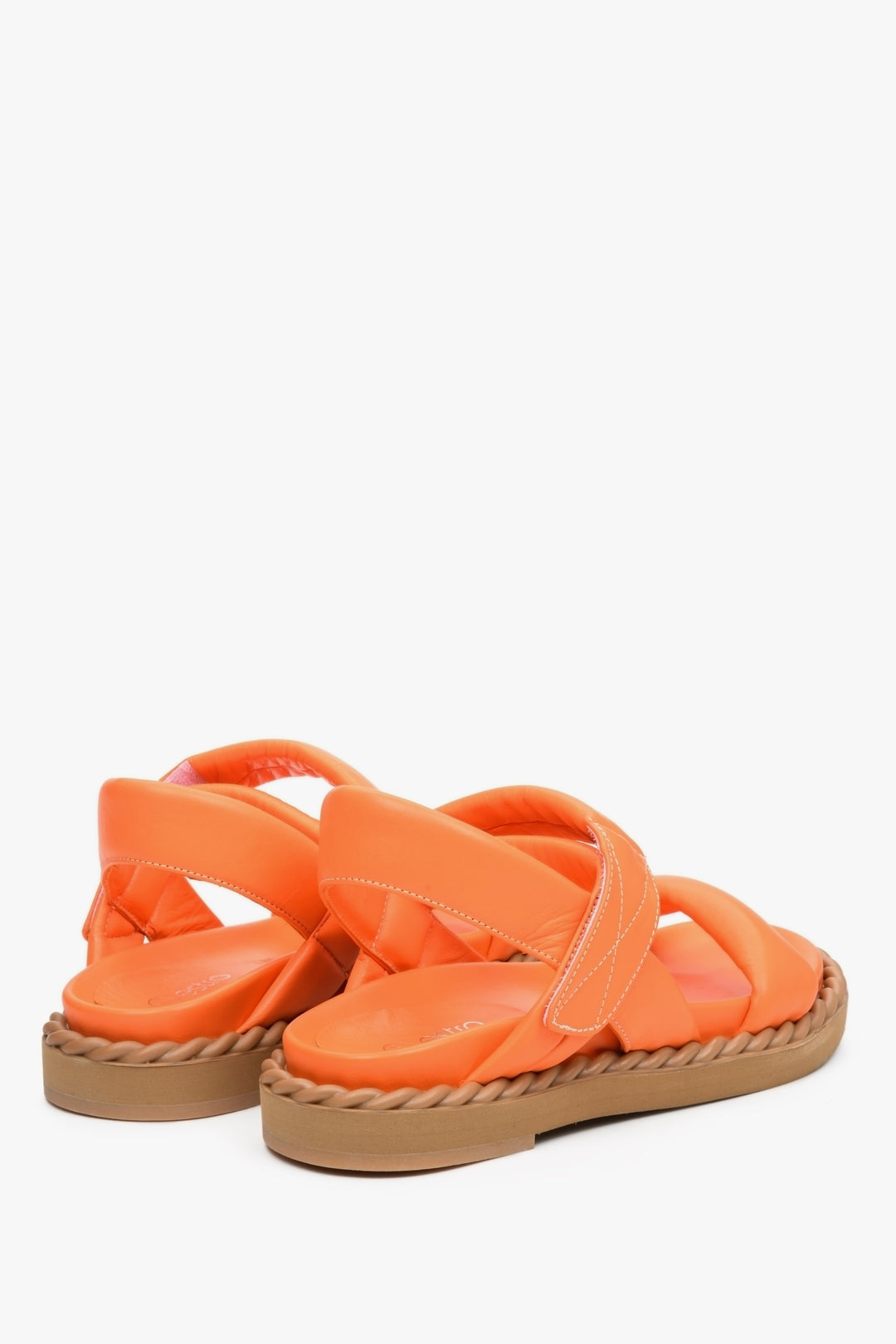 Women's orange flat sandals for summer on a comfortable, flexible sole - the presentation of the back and side of the shoes.