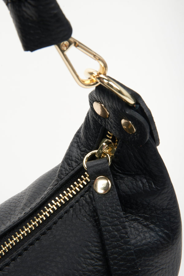 Black shoulder natural leather women's bag - vlose-up on a zipper tossel.