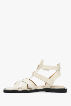 Women's leather sandals with thin straps on a flat heel Estro - shoe profile in white.