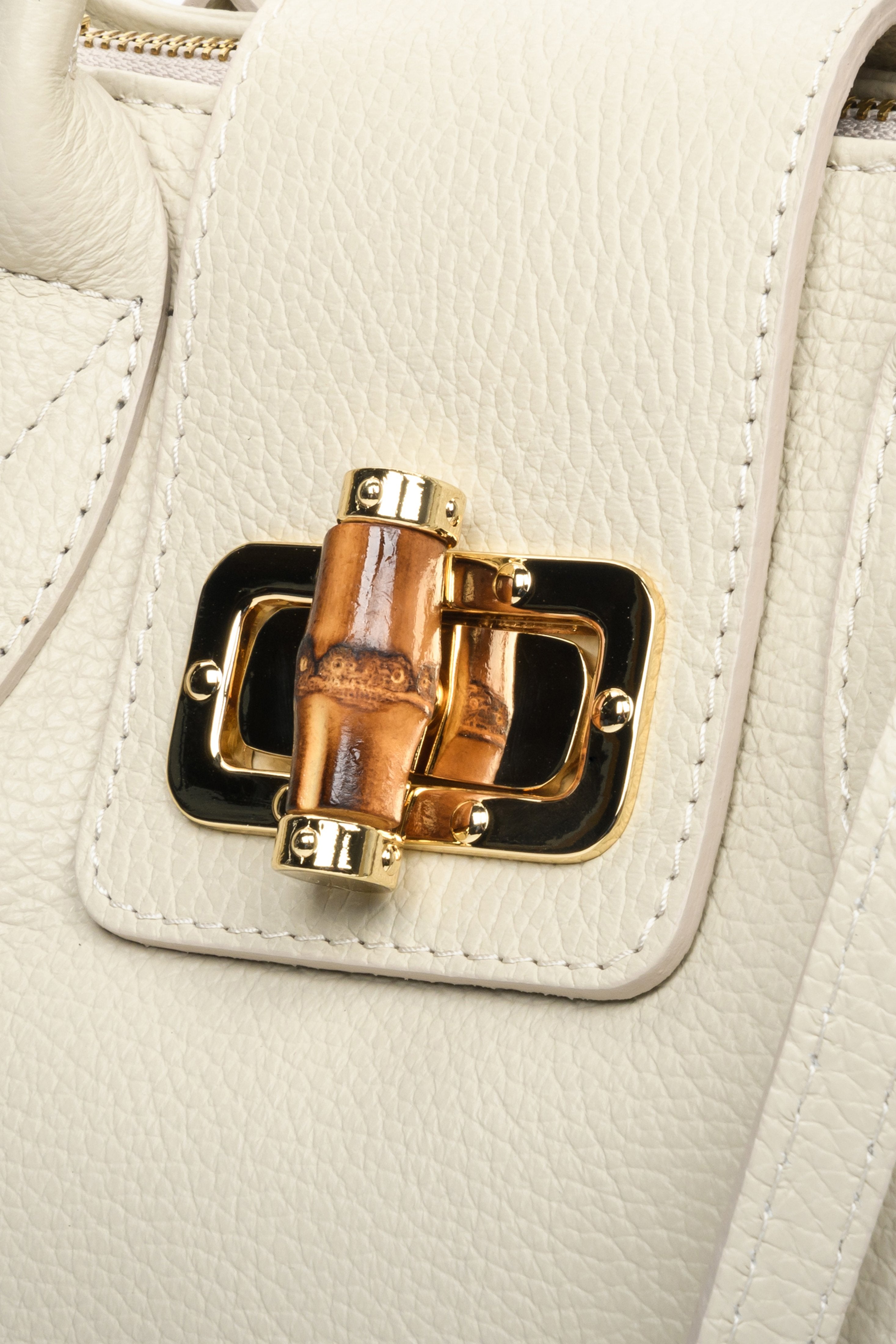 Light beige leather handbag of Italian production. Close-up of the details.