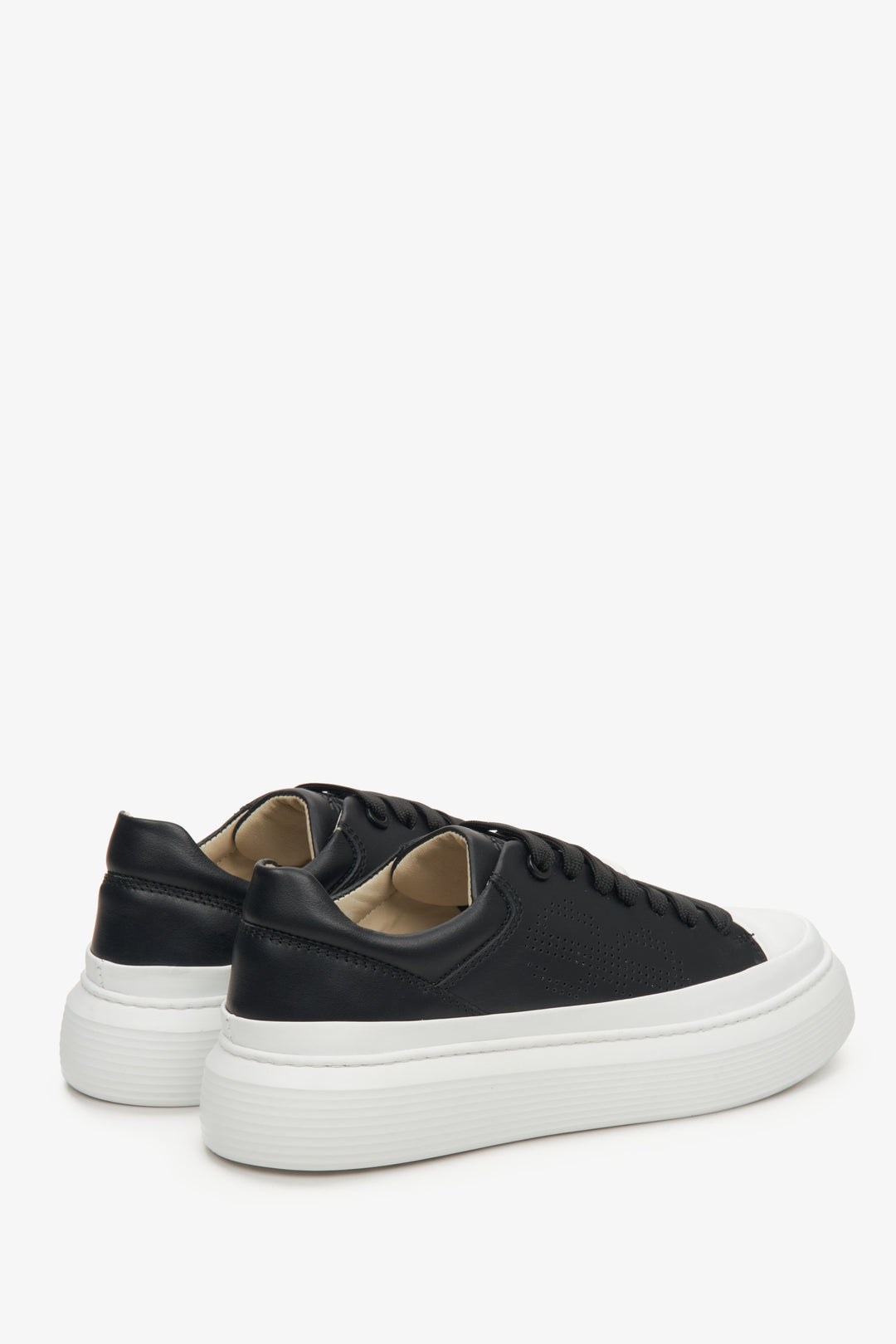 Women's black Estro natural leather sneakers for spring - close-up of the heel counter and sideline.