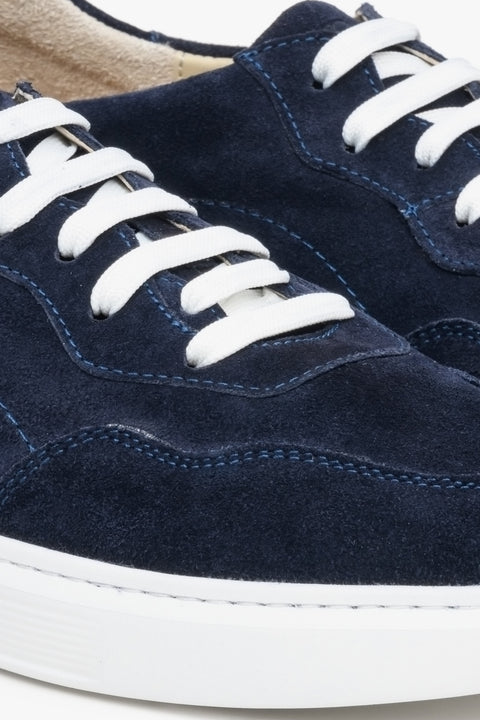 Navy blue velour men's sneakers with lacing - close-up of the stitching system.