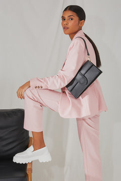 Women's small leather shoulder bag - presentation of outfit with the product.