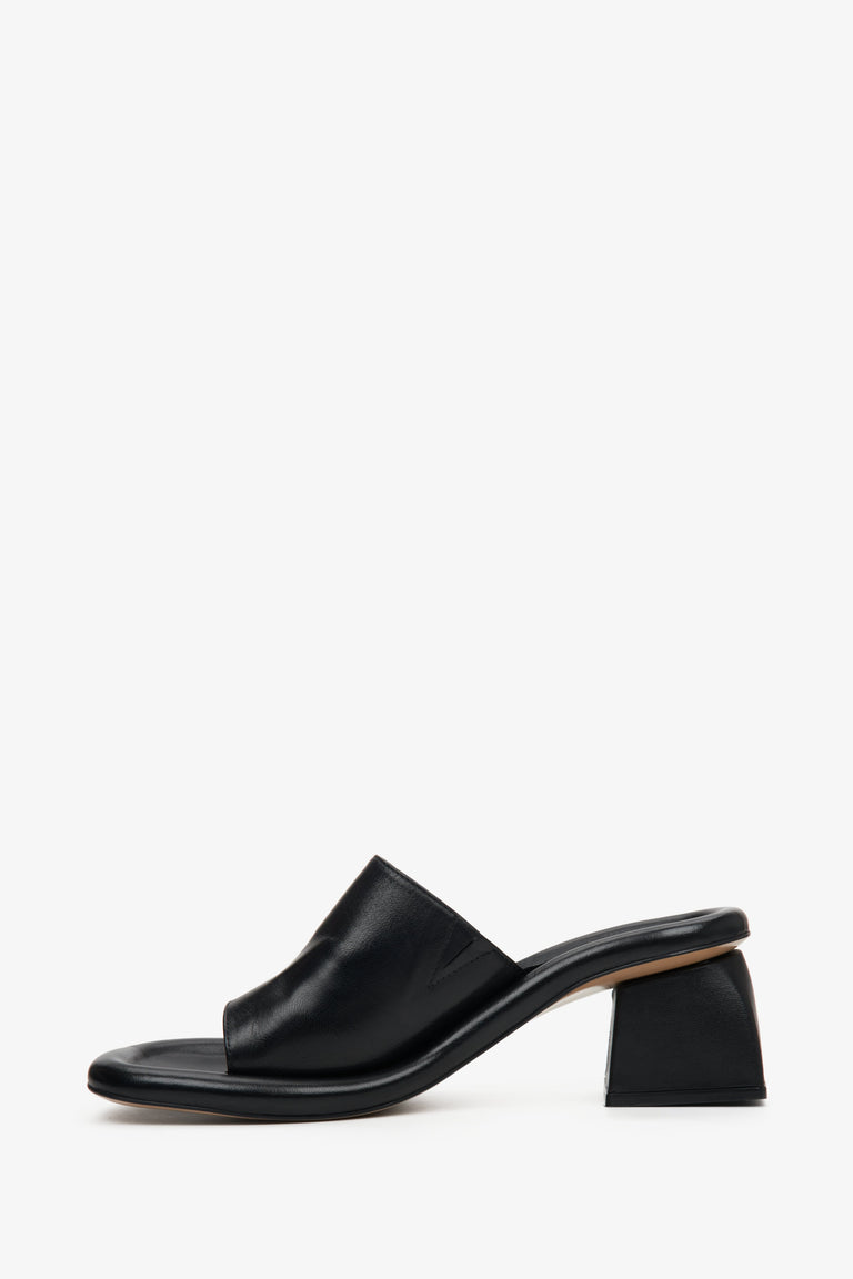 Stylish black mules for women made of natural leather on a square heel - the profile of the shoes.