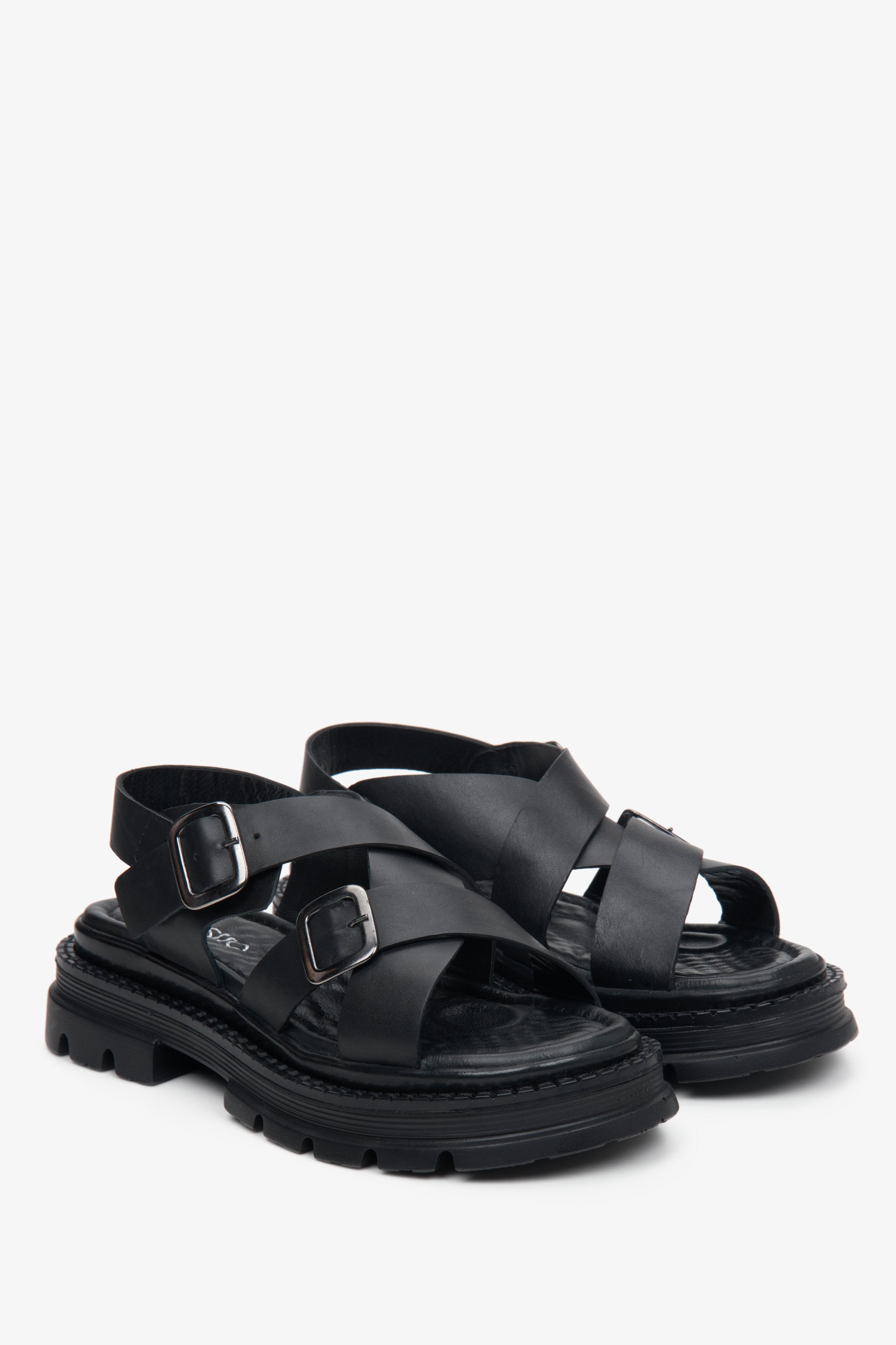 Women's Estro black leather sandals with crossed straps.