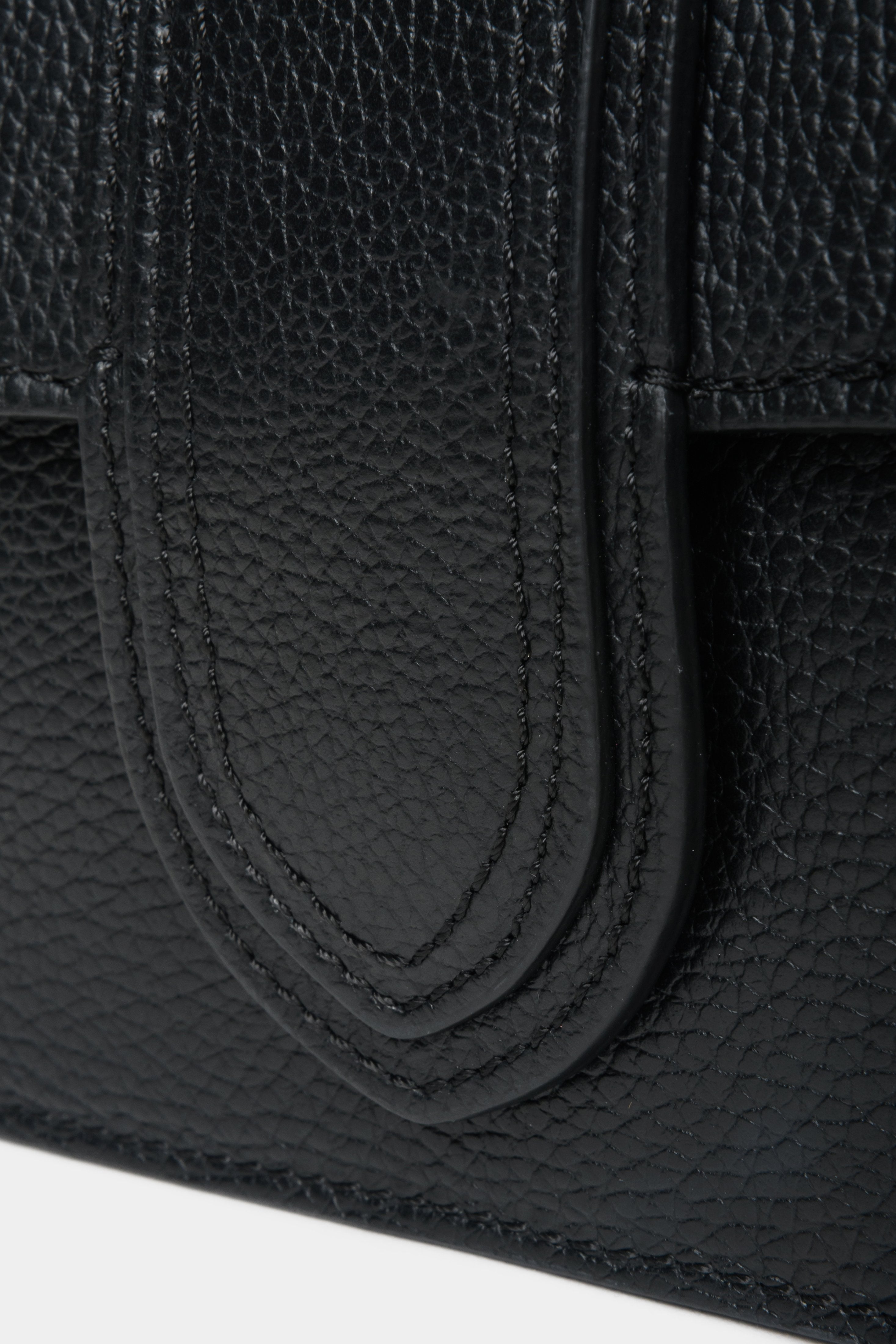 Black Estro women's leather handbag - close-up of decorative clasp.