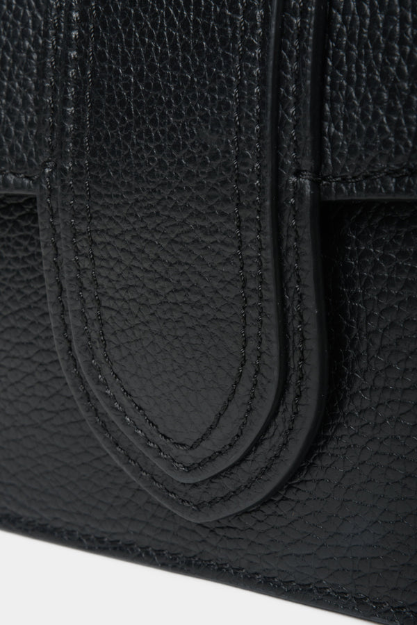 Black Estro women's leather handbag - close-up of decorative clasp.