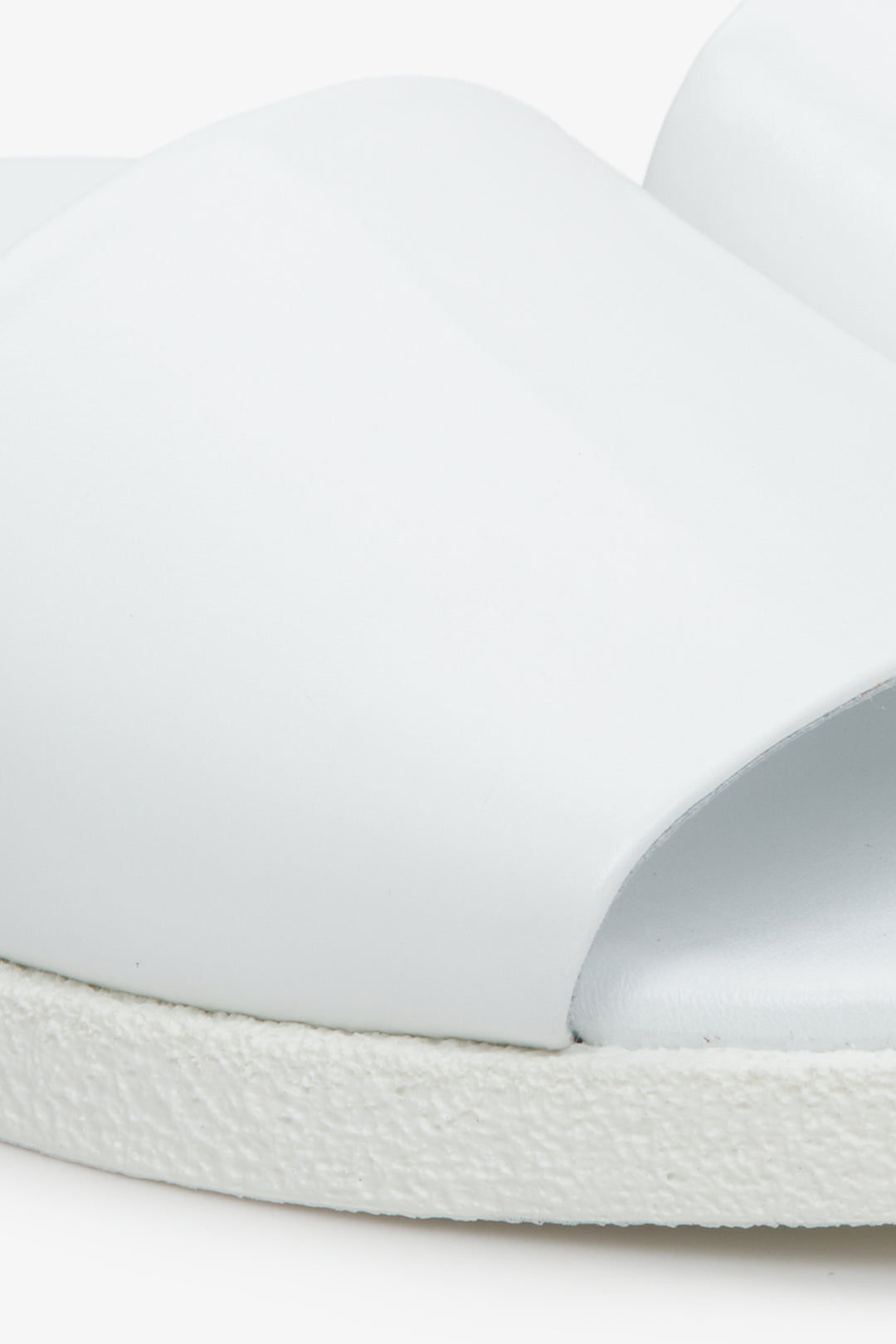 Women's white Estro flat slides - close-up on details.