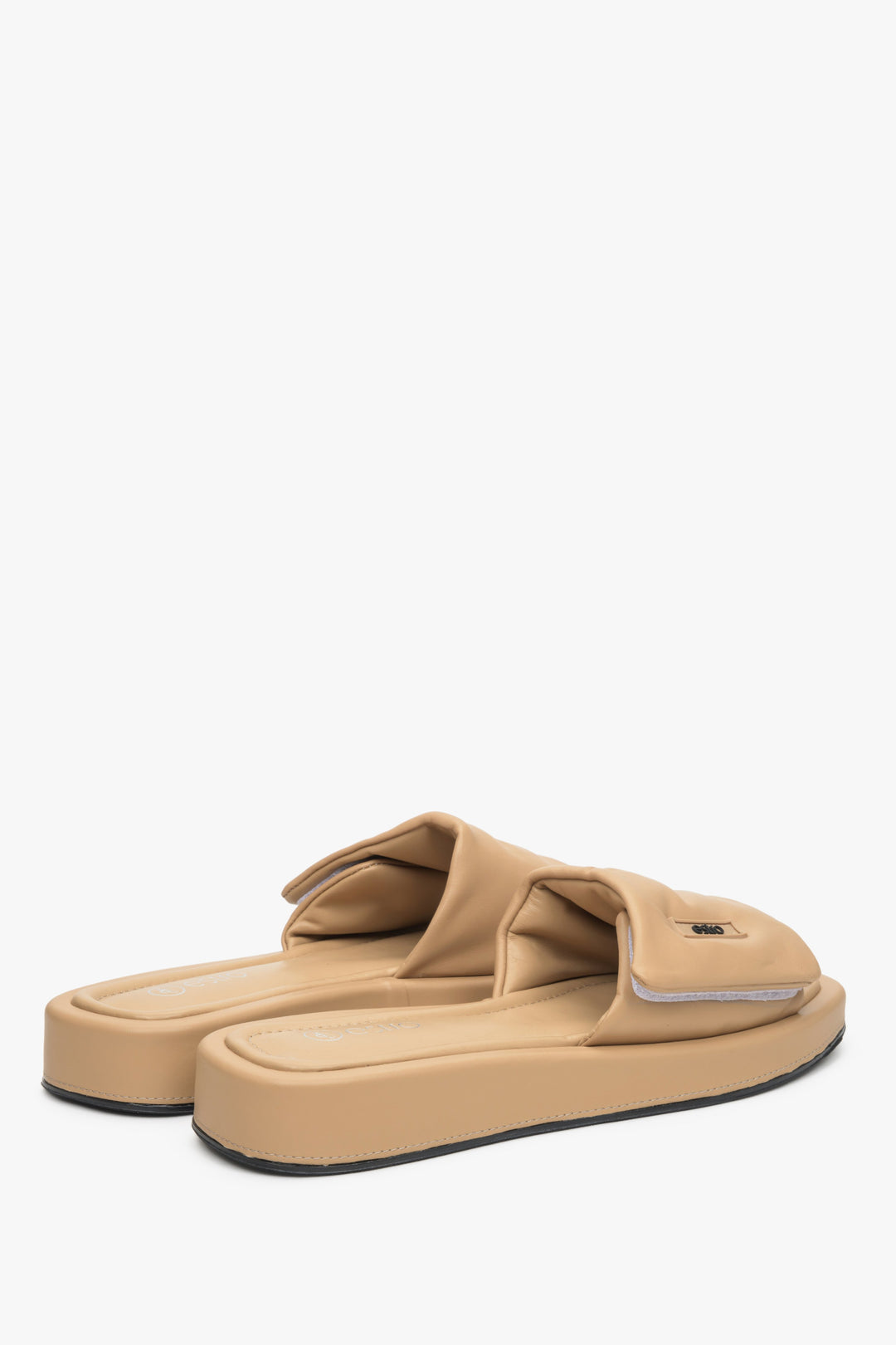 Leather slide sandals by Estro in beige.